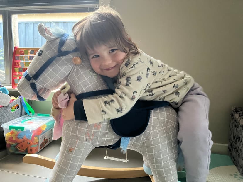 little girl on rocking horse