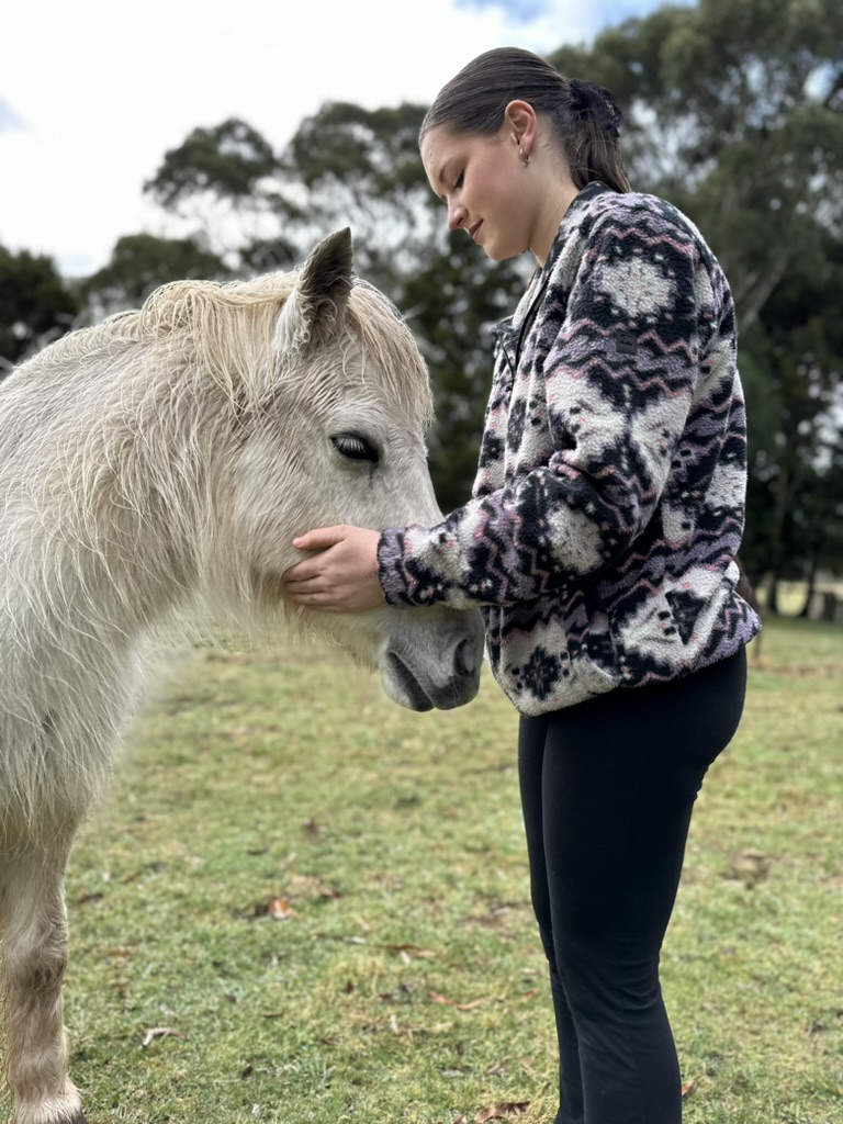 girl hugging horse head